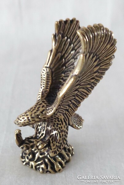 Miniature brass figure of a flying eagle catching a snake