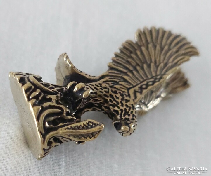 Miniature brass figure of a flying eagle catching a snake