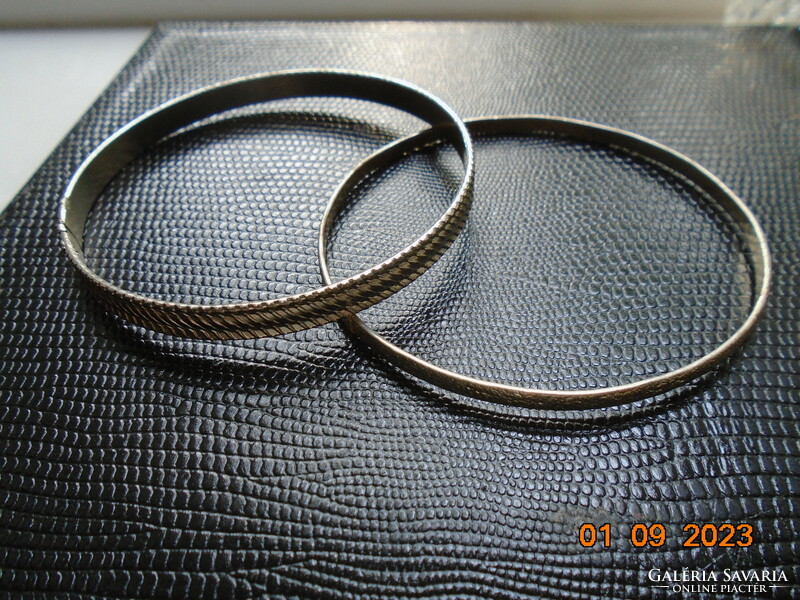 Two silver-colored embossed bracelets