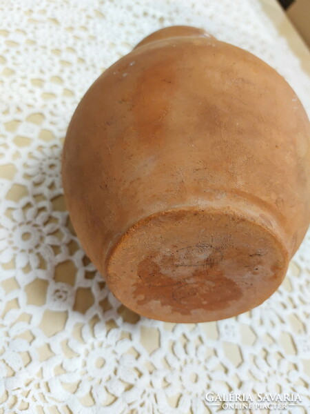 An old mug, a glazed earthenware pot, a jar, a jug, a tumbler