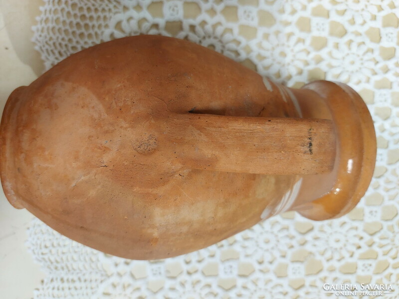 An old mug, a glazed earthenware pot, a jar, a jug, a tumbler