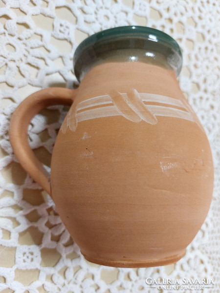 An old mug, a glazed earthenware pot, a jar, a jug, a tumbler