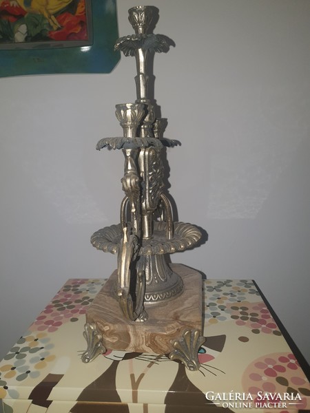 Antique copper candle holder on a marble base