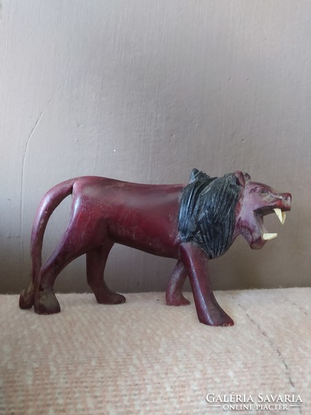 Marked lion statue made of hard wood