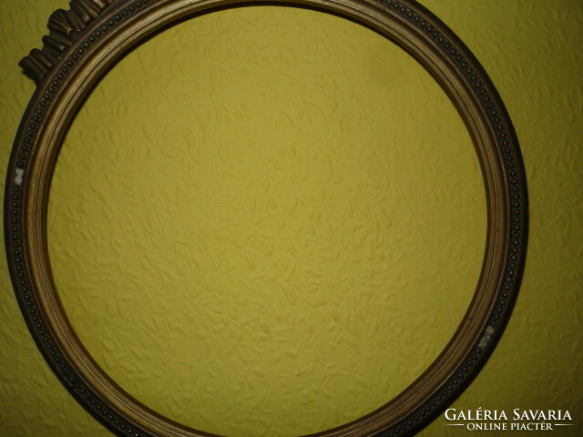 Round antique gold wooden frame.