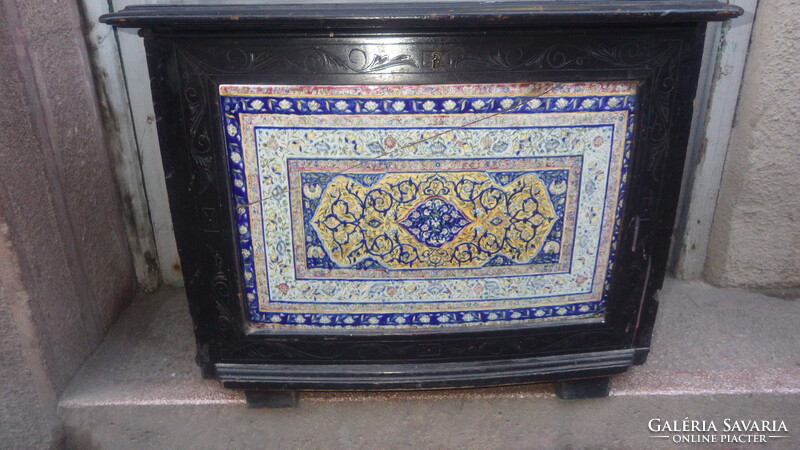 Older, openable wooden chest with painted faience inlay on the front, storage