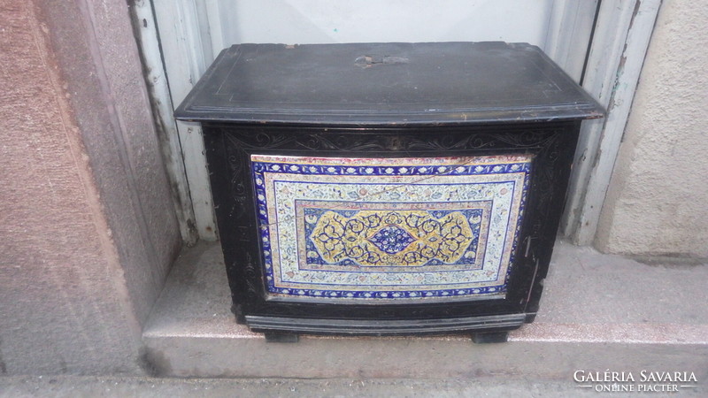 Older, openable wooden chest with painted faience inlay on the front, storage