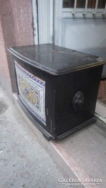 Older, openable wooden chest with painted faience inlay on the front, storage