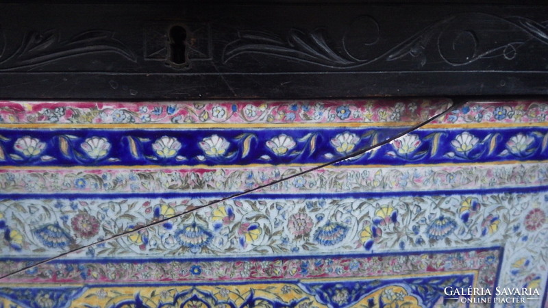 Older, openable wooden chest with painted faience inlay on the front, storage