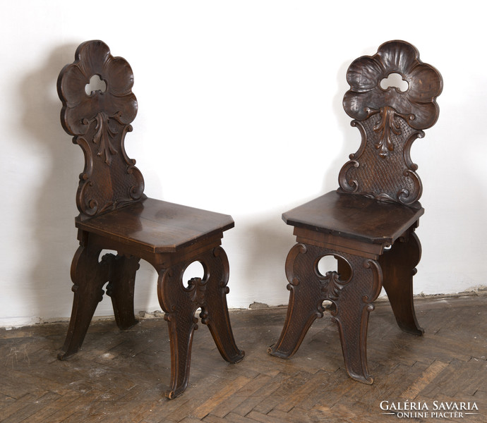 Pair of carved wooden chairs - with stylized plant decor