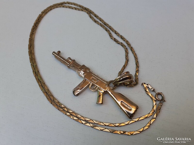Old, beautiful, richly gilded military pendant on a richly gilded chain