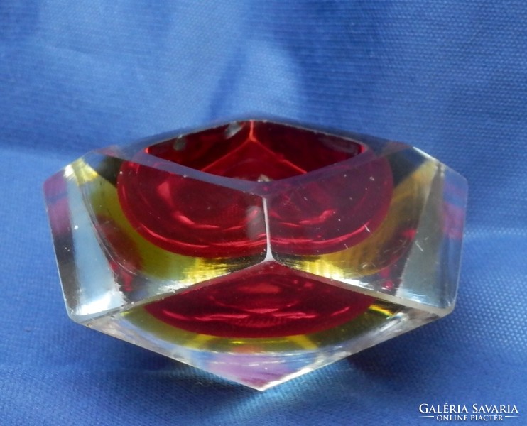 A multi-colored decorative object inlaid on a crystal sheet
