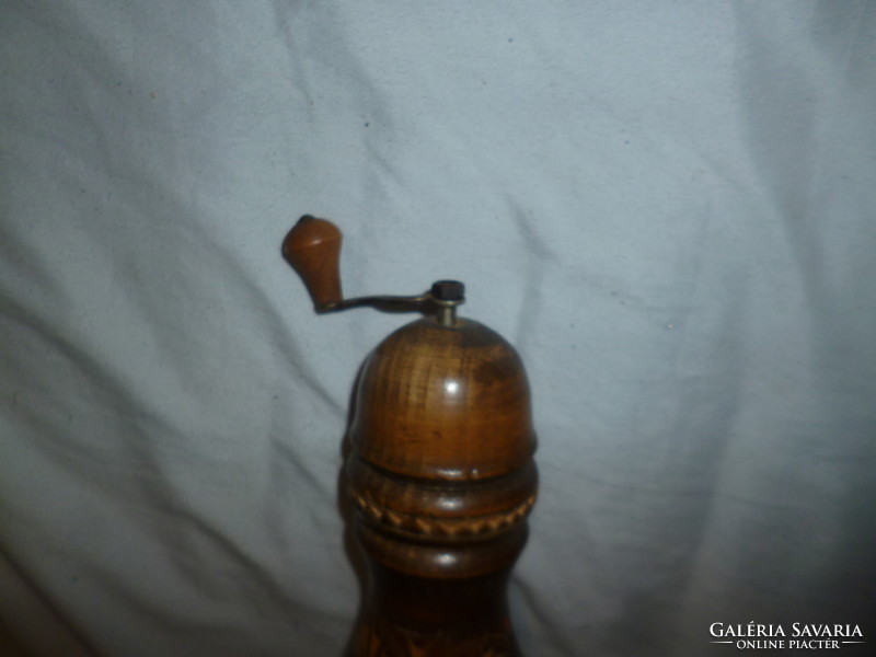 Old wooden pepper grinder coffee grinder with carved decoration