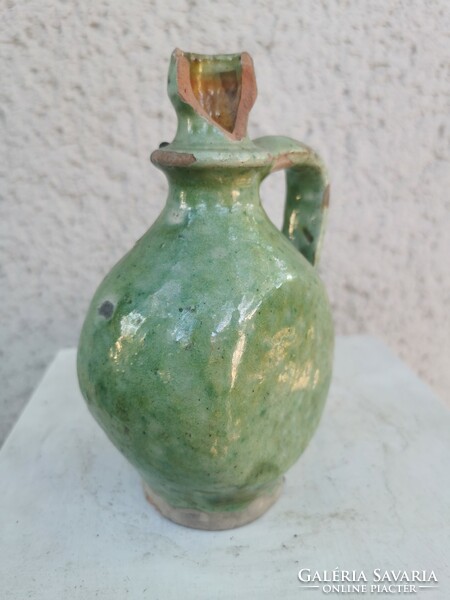 A small jar with an inscription, flattened sides