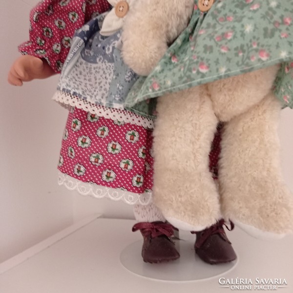 Marked porcelain doll with teddy bear, stand 42 cm high