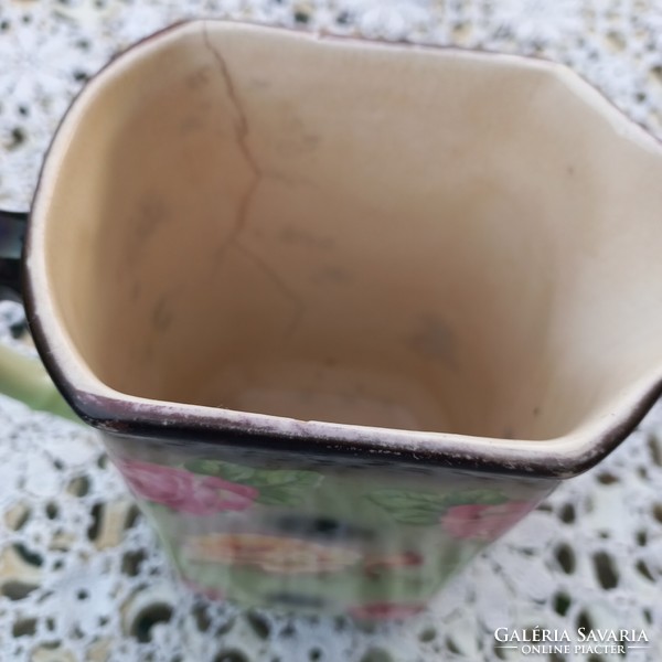 Antique earthenware jug with flowers