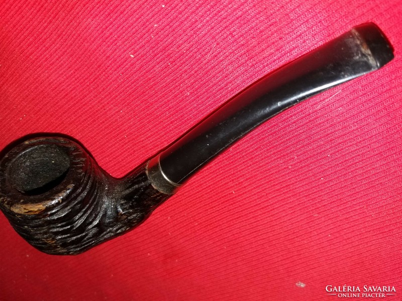 An old wooden pipe with a curved stem and a ribbed head, beautifully carved according to the pictures 3.