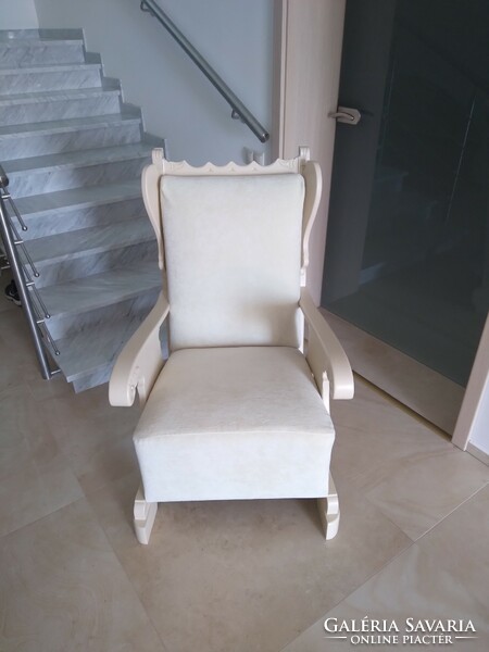 An old armchair with wings, with new springs and upholstery.