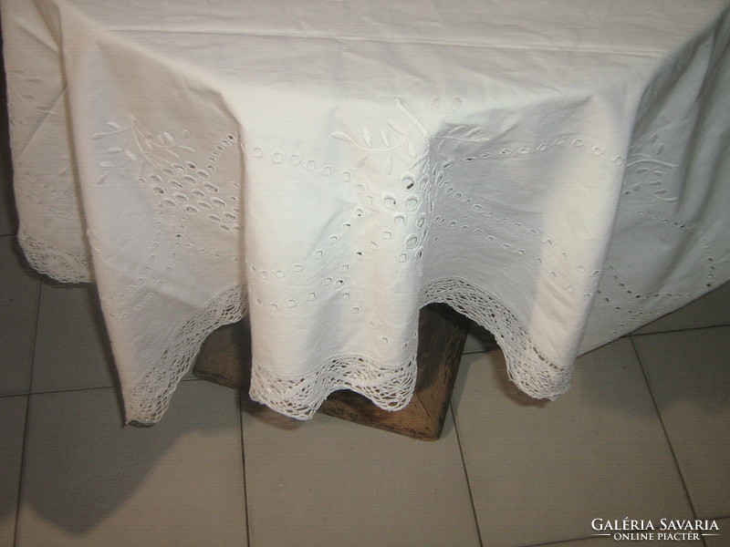 A beautiful snow-white antique huge madeira tablecloth with a lace edge