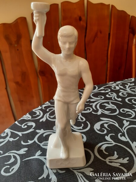 Porcelain figure carrying the Olympic flame