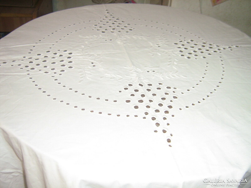 A beautiful snow-white antique huge madeira tablecloth with a lace edge