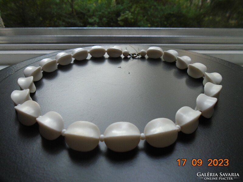 Old necklaces made of larger white rectangular beads with concave sides and a copper clasp