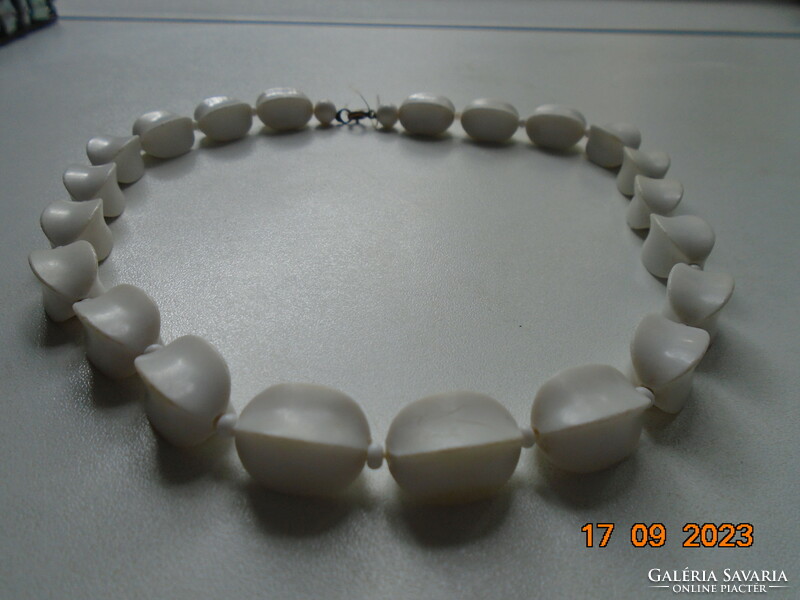 Old necklaces made of larger white rectangular beads with concave sides and a copper clasp