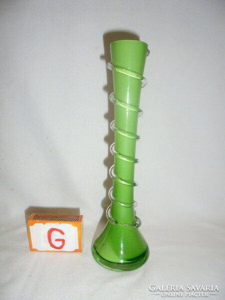 Old green glass vase with twisted decoration in a circle