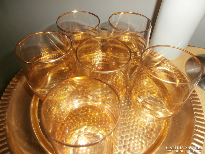 Retro gold striped glasses on a metal tray