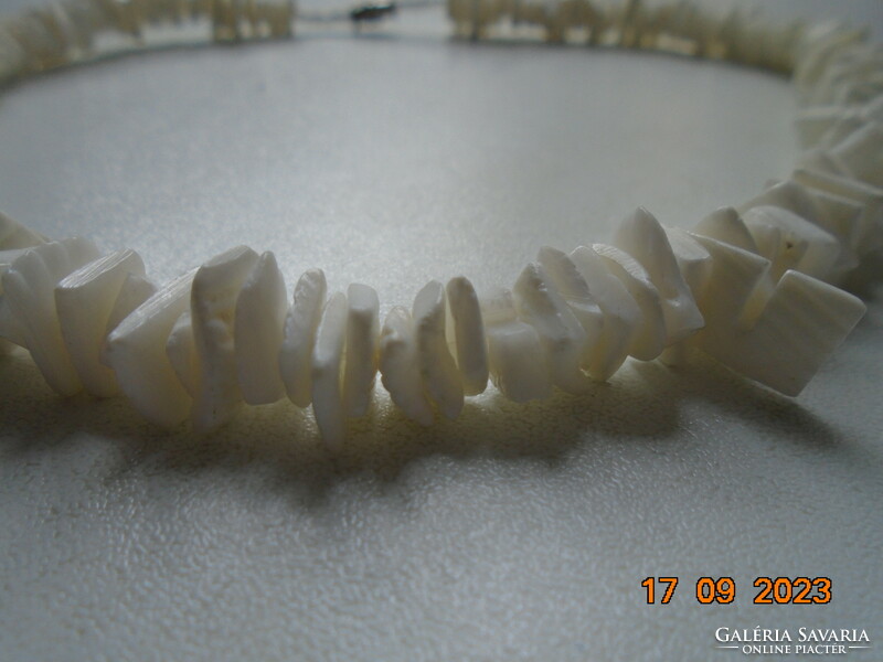 White seashell necklace tightly strung with a screw clasp
