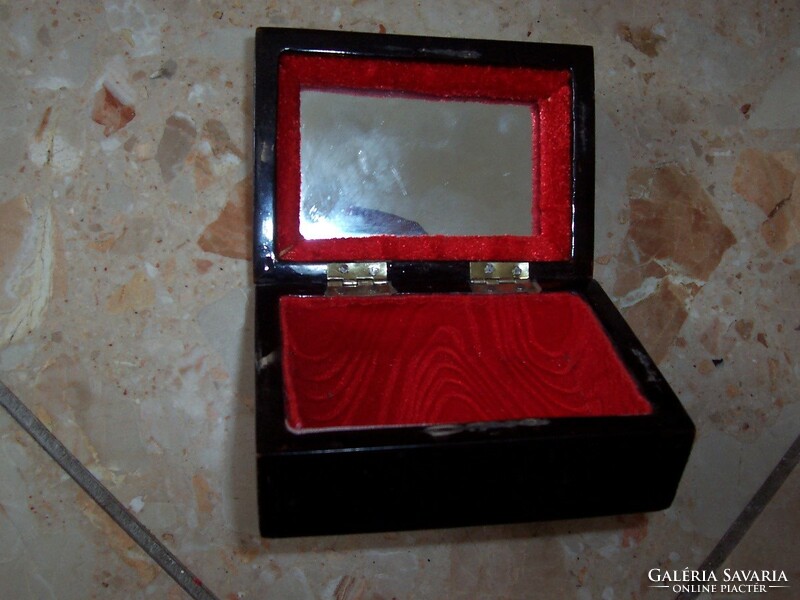 Inside a mirrored small box of mother of pearl inlaid