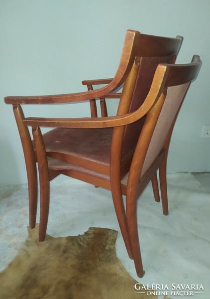 A pair of vintage chairs with curved lines