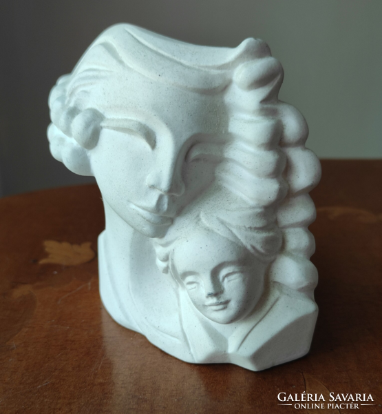 A charming plaster statue of a mother with her child for a fireplace or other interior decoration