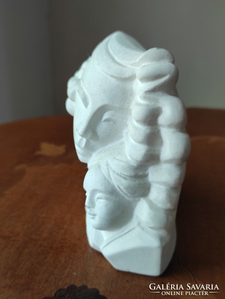 A charming plaster statue of a mother with her child for a fireplace or other interior decoration