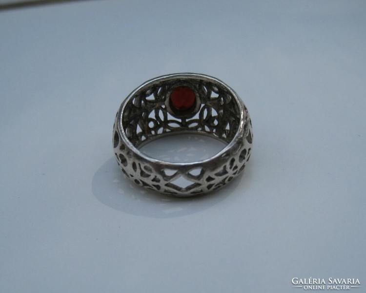 Garnet stone silver ring with an openwork pattern