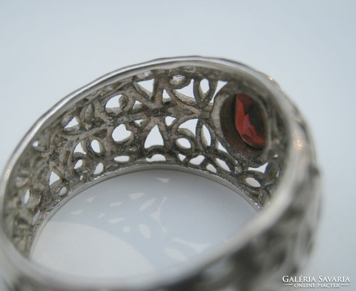Garnet stone silver ring with an openwork pattern