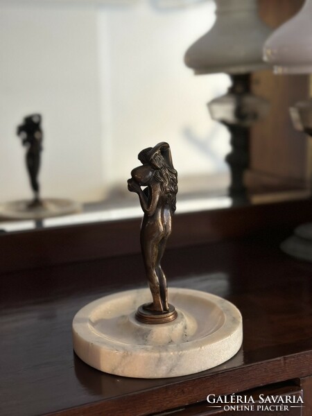 Beautiful bronze statue of a woman with a jug on a marble base