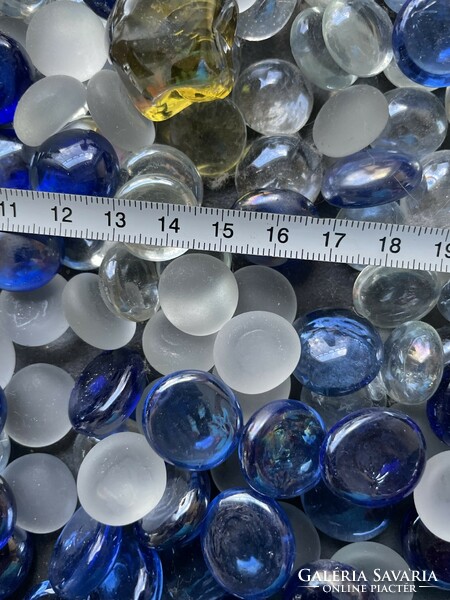 Lots of translucent, iridescent ornamental stones and pebbles with blue-white tones