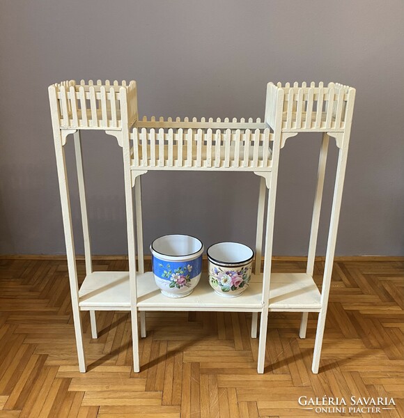 A large wooden stand for a flower holder decorated with Art Nouveau sticks