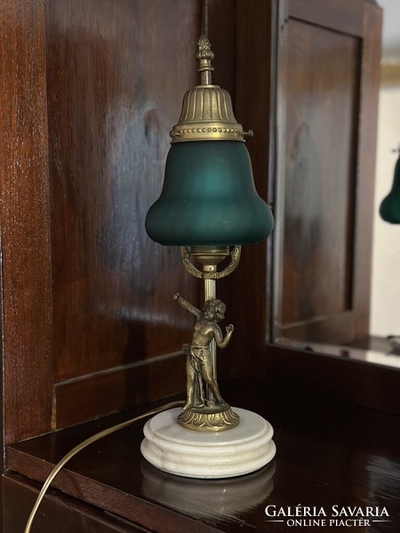 Elegant table lamp with a green shade and a bronze statue on a marble base