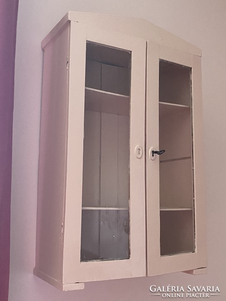 Pink wall cabinet with shelves