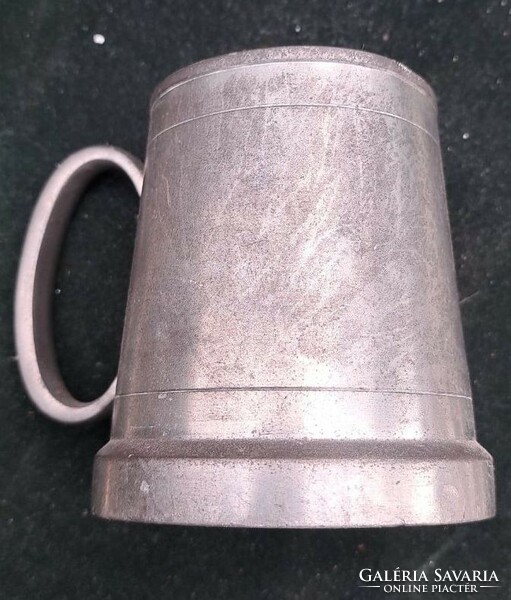 A cup with a pewter handle