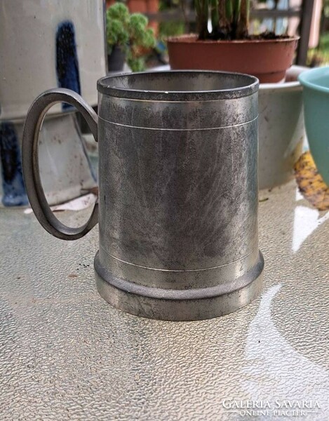A cup with a pewter handle