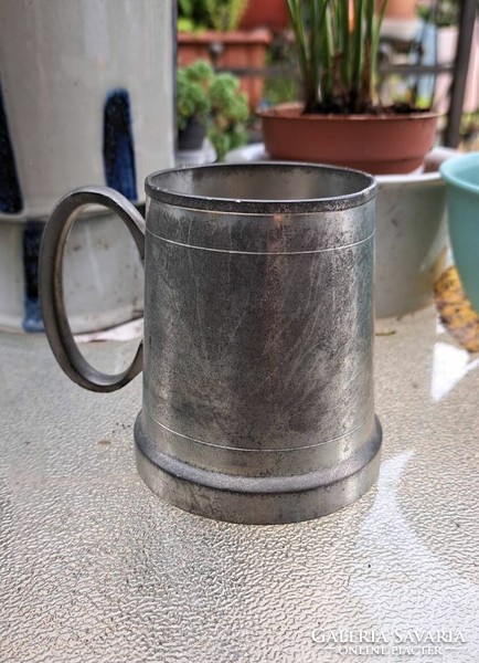 A cup with a pewter handle