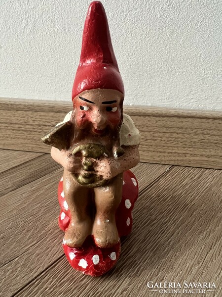 Antique gypsum Christmas decoration with a dwarf sitting on a mushroom and a horn