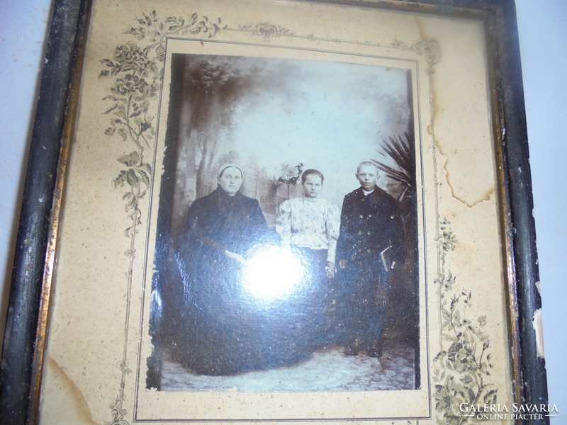 Antique family photo in a frame, under glass