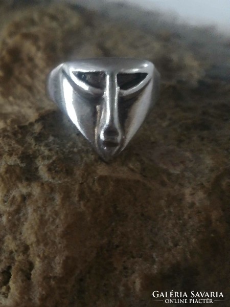 Silver ring with an old mask