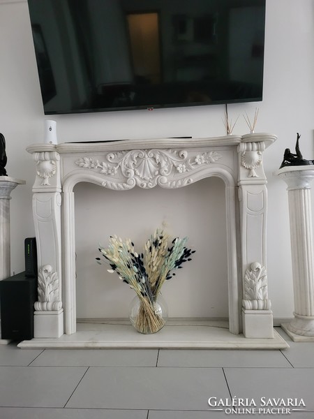 White marble fireplace with floral decoration