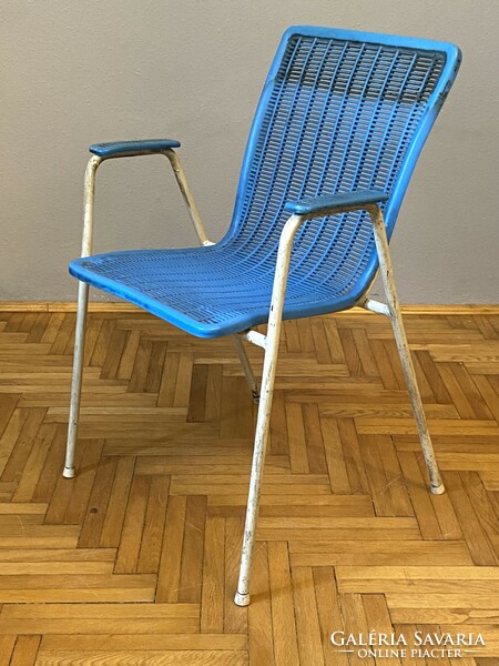 Blue retro lounge chair with an exciting shape for the terrace in the conservatory