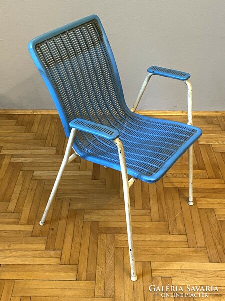 Blue retro lounge chair with an exciting shape for the terrace in the conservatory